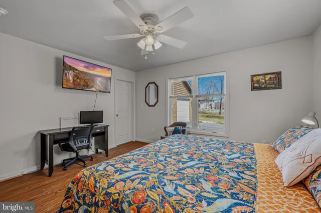 a bedroom with a bed and a desk