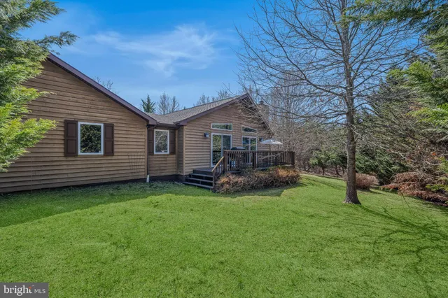 a view of a house with a backyard and sitting area