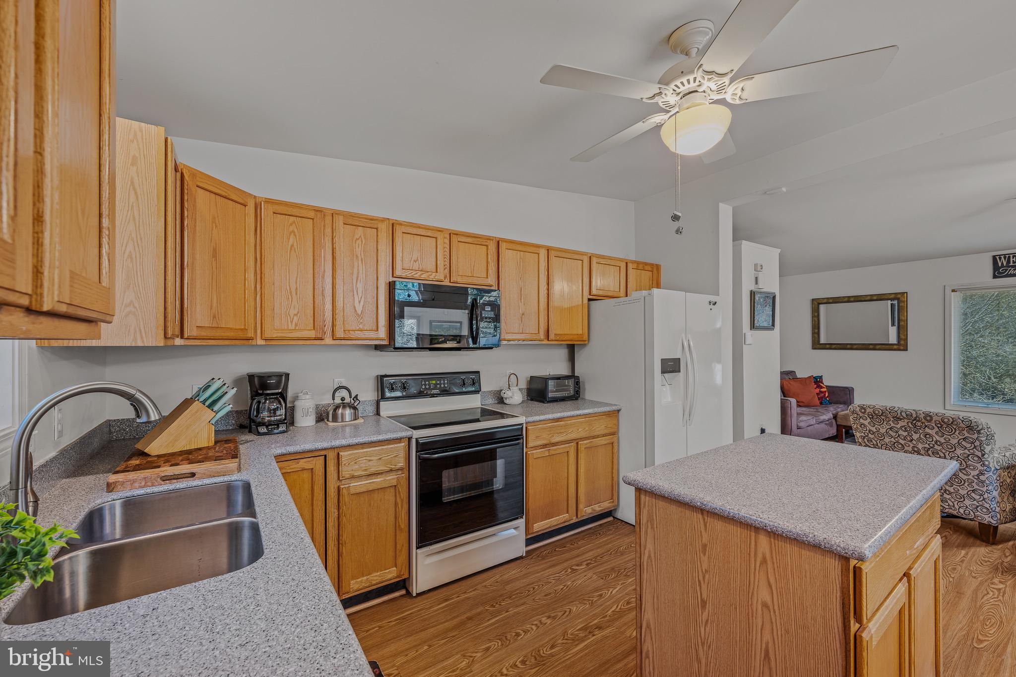 72 Medfords Lane Berkeley Springs, WV 25411 - Photo 4 of 52 a kitchen with stainless steel appliances granite countertop a stove a sink dishwasher and a refrigerator with wooden floor