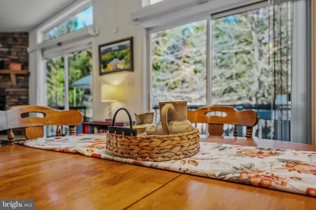 a living room with large window and furniture