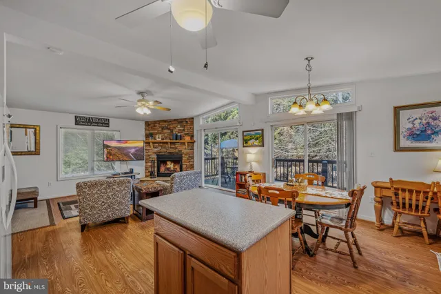 a view of a dining room with furniture a chandelier and wooden floor