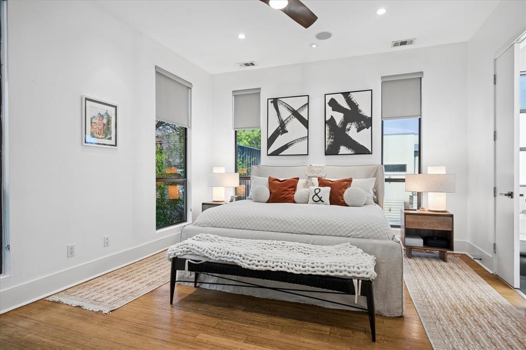 432 Trinity River Circle Dallas, TX 75203 - Photo 23 of 40 Spacious primary bedroom with new remote control and app-controlled ceiling fan, built-in ceiling speakers, and closet featuring customizable cabinetry.