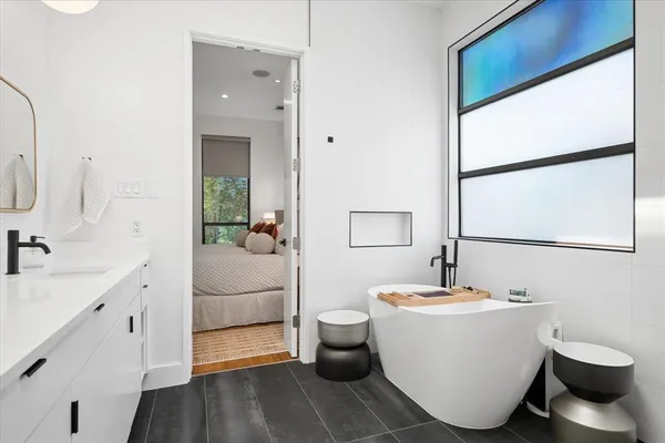 a spacious bathroom with a double vanity sink a toilet and shower