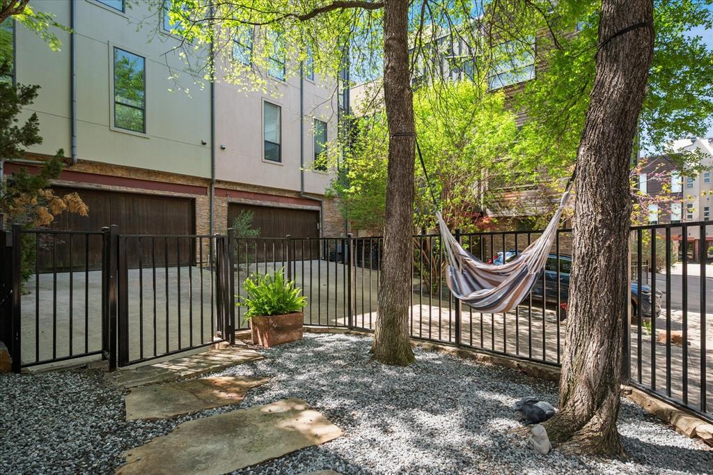 432 Trinity River Circle Dallas, TX 75203 - Photo 3 of 40 Gated lawn with pebbles and large shade trees.