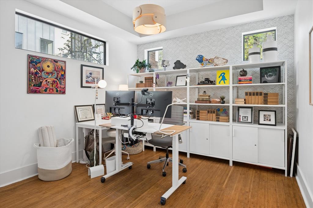 432 Trinity River Circle Dallas, TX 75203 - Photo 6 of 40 Home office with a feature backdrop wall covered in three-dimensional metallic Schumacher wallpaper. Office shelving and desks will convey if requested.