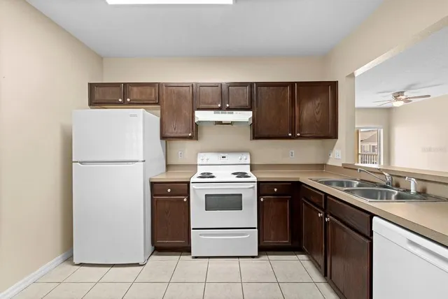 a kitchen with a stove top oven and refrigerator