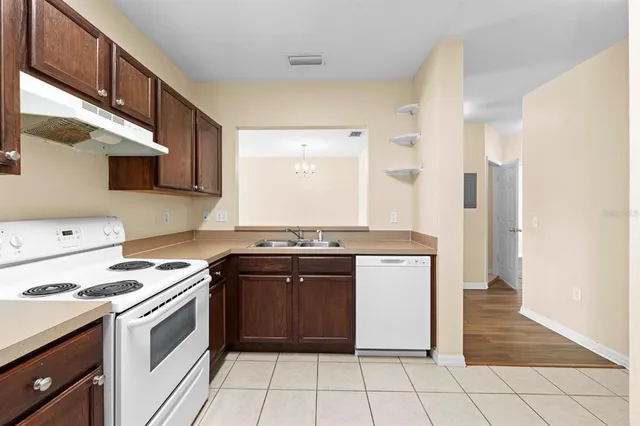 a kitchen with stainless steel appliances granite countertop a stove and a refrigerator