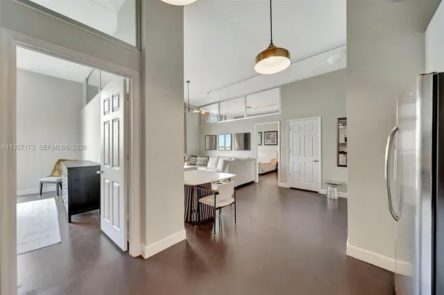 a view of a kitchen with refrigerator and windows