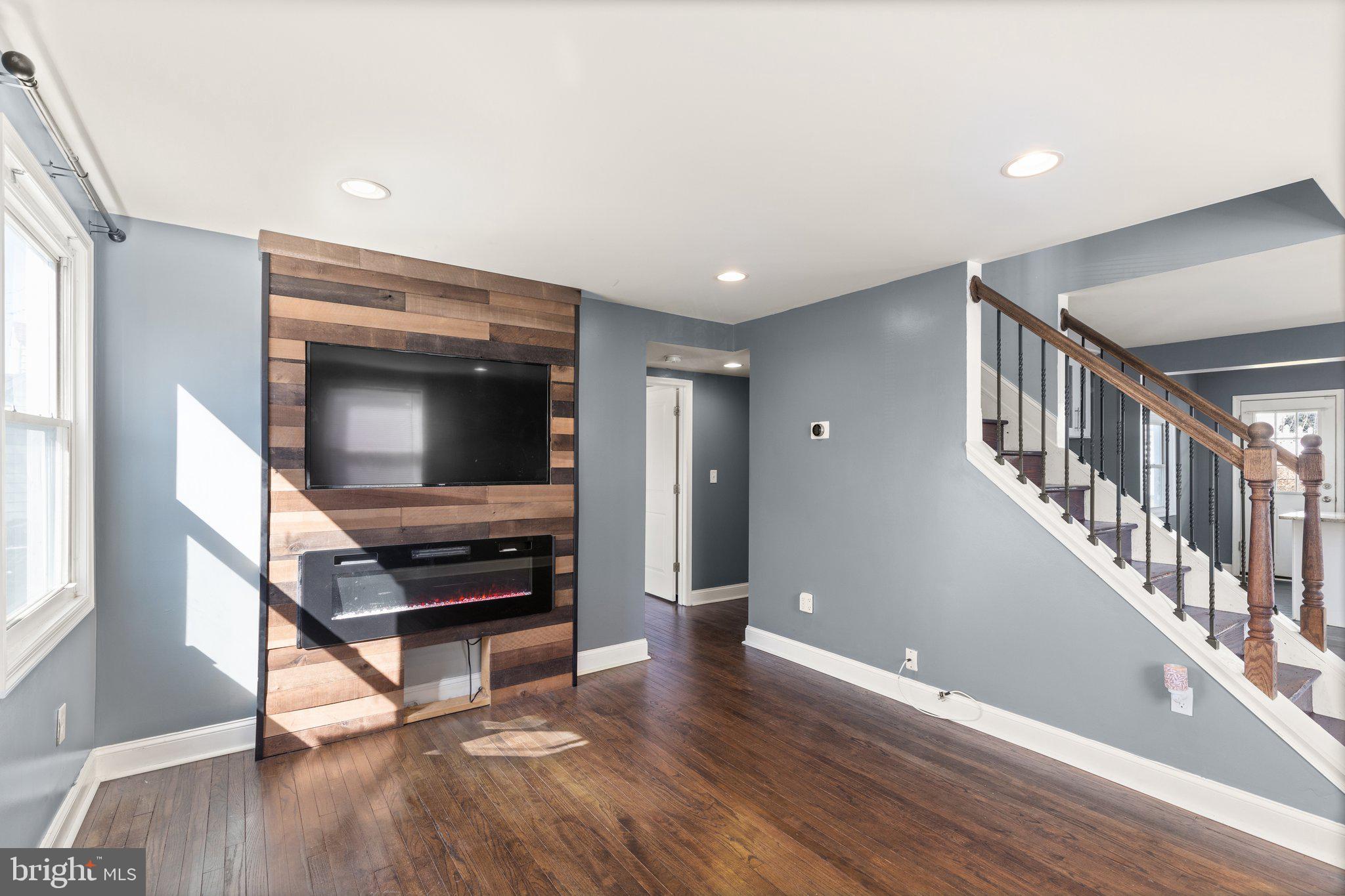 7400 Waymouth Way Baltimore, MD 21222 - Photo 4 of 27 Shiplap with built in fireplace and TV