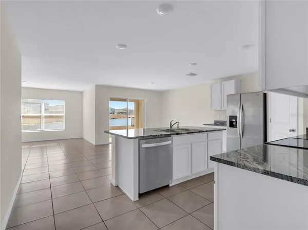 a kitchen with stainless steel appliances granite countertop a sink and a stove