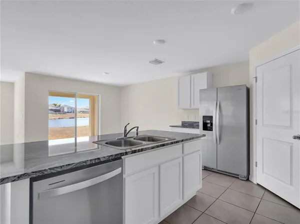 a kitchen with stainless steel appliances granite countertop a sink and a granite counter tops