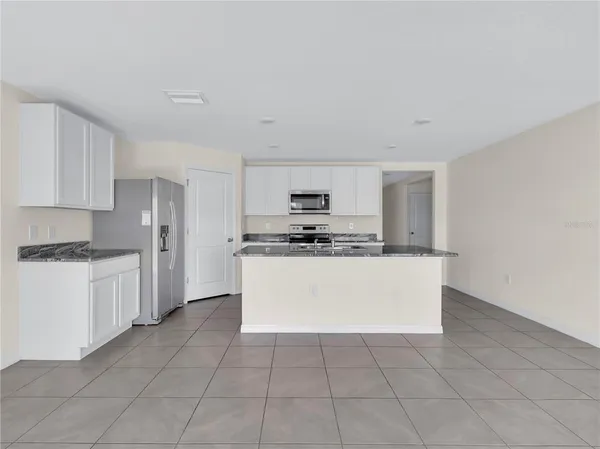 a kitchen with cabinets and white appliances