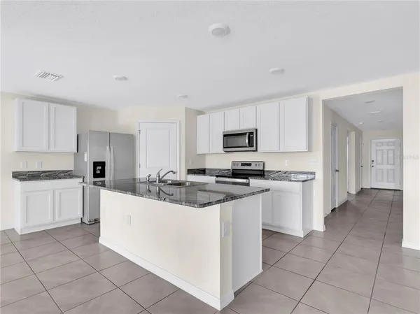 a kitchen with stainless steel appliances and white cabinets