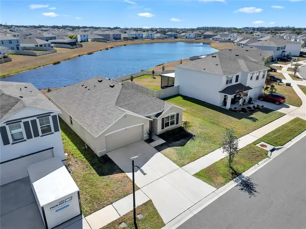 an aerial view of a house with a yard