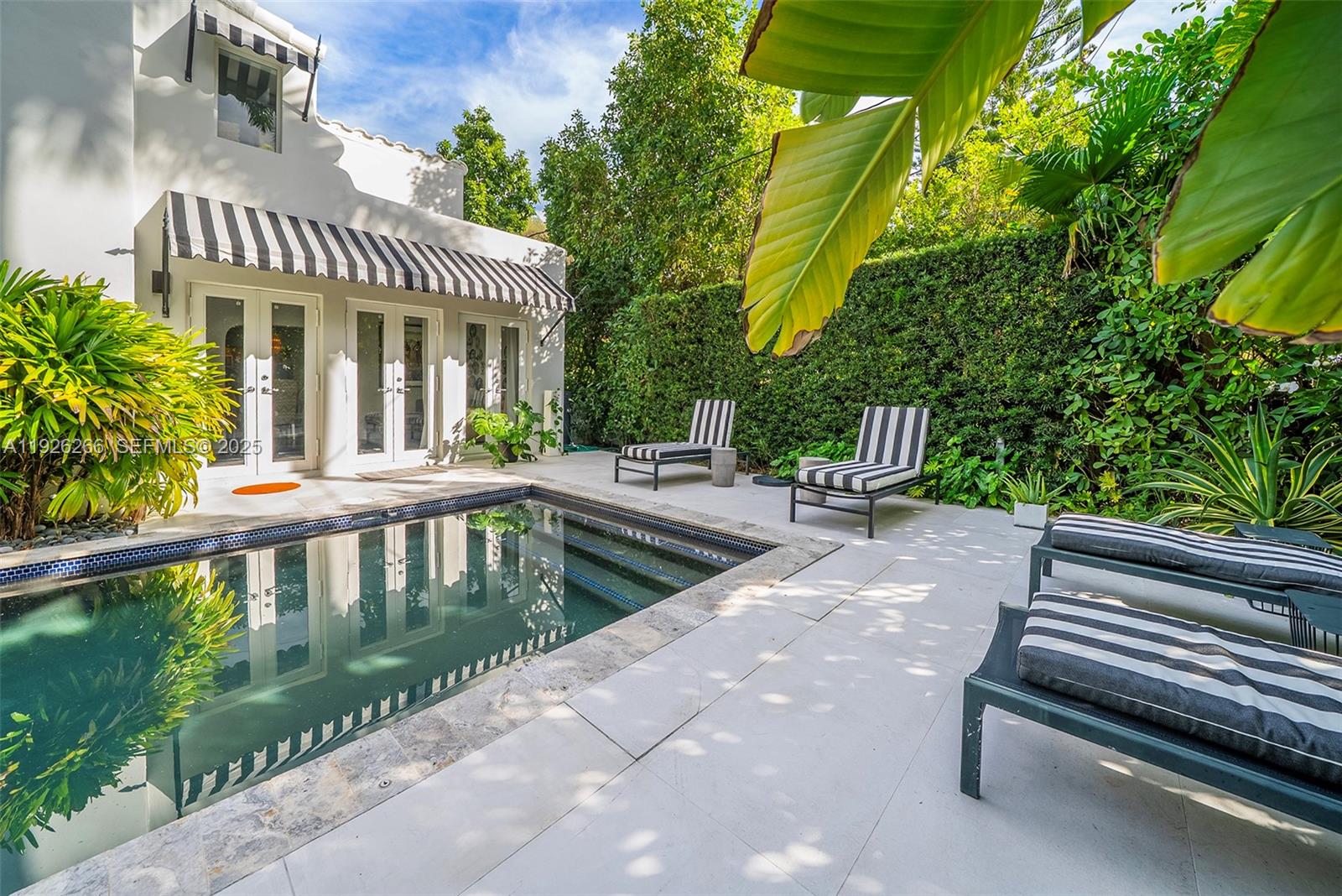 2729 North Bay Road Miami Beach, FL 33140 - Photo 14 of 41 a view of a patio with a table and chairs