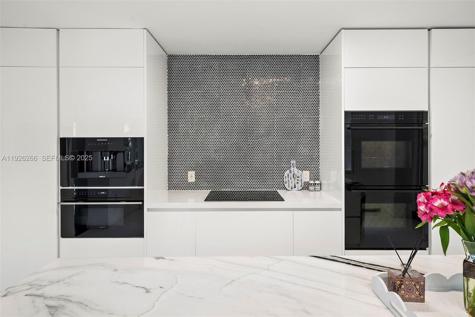 2729 North Bay Road Miami Beach, FL 33140 - Photo 22 of 41 a kitchen with a refrigerator and a stove