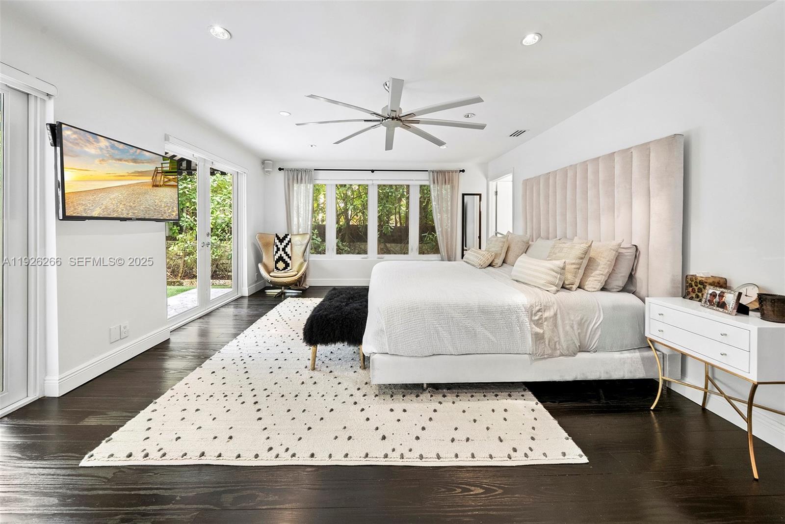 2729 North Bay Road Miami Beach, FL 33140 - Photo 24 of 41 a large bed sitting in a bedroom next to a window