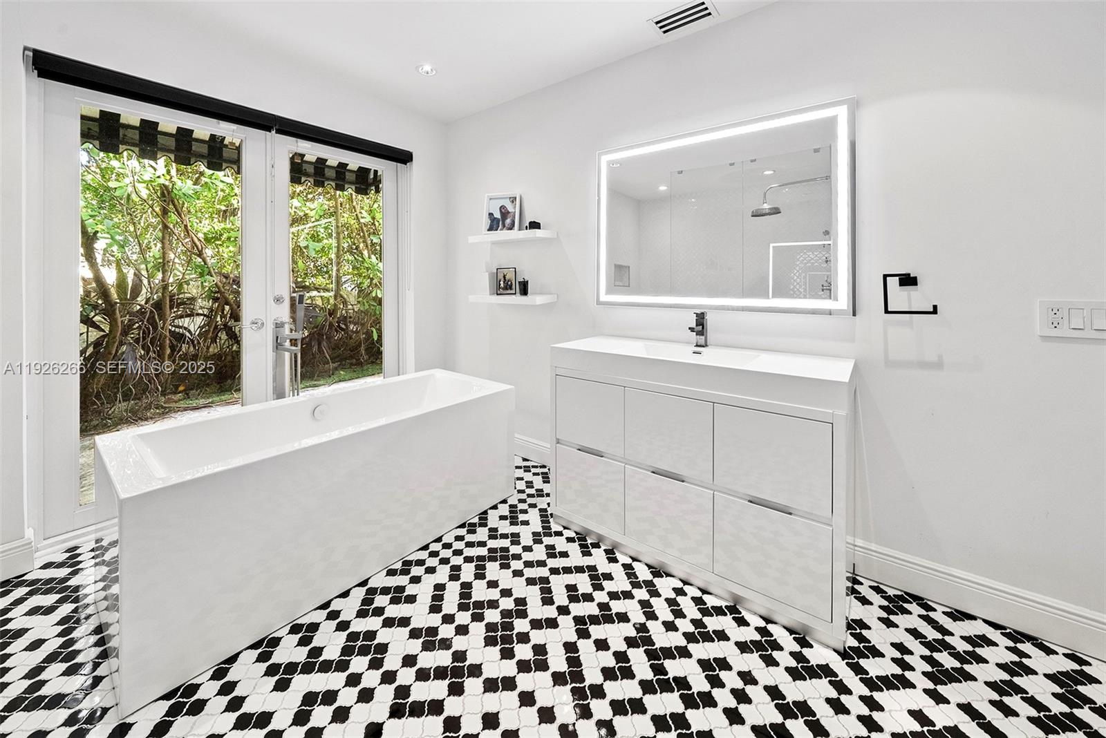 2729 North Bay Road Miami Beach, FL 33140 - Photo 26 of 41 a bathroom with a sink and a mirror