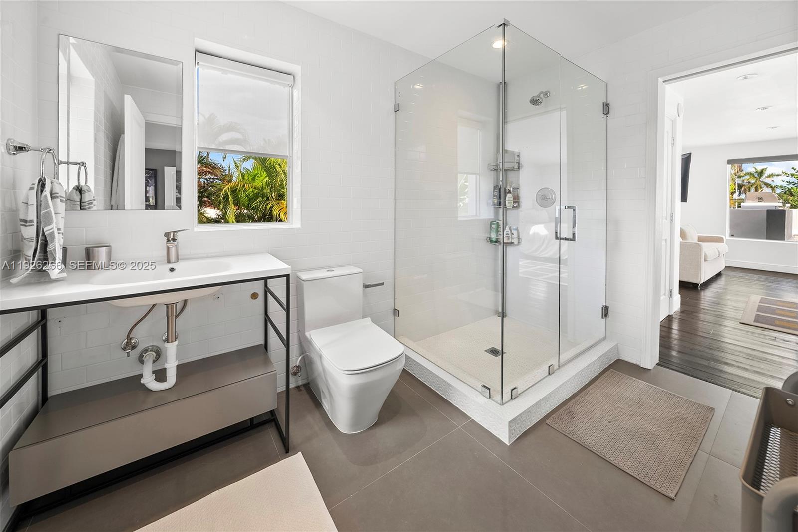 2729 North Bay Road Miami Beach, FL 33140 - Photo 29 of 41 a bathroom with a sink a toilet and shower