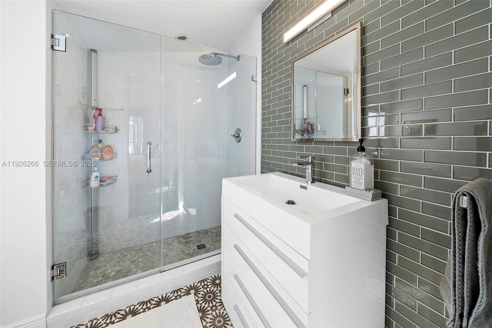 2729 North Bay Road Miami Beach, FL 33140 - Photo 32 of 41 a bathroom with a sink a toilet and shower