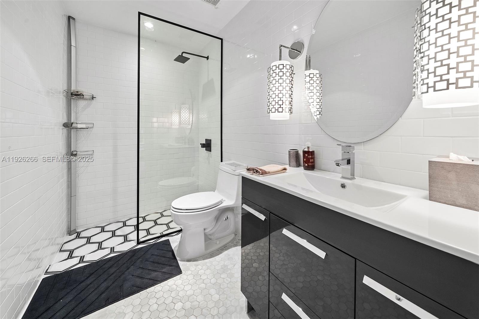 2729 North Bay Road Miami Beach, FL 33140 - Photo 35 of 41 a bathroom with a double vanity sink mirror and toilet