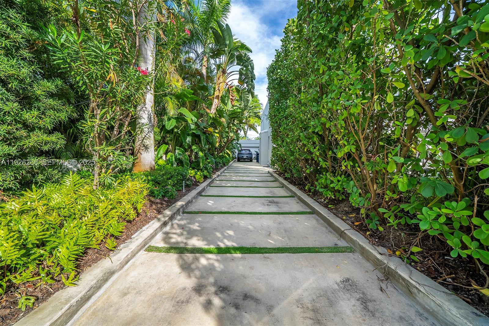 2729 North Bay Road Miami Beach, FL 33140 - Photo 40 of 41 a view of a garden with pathway