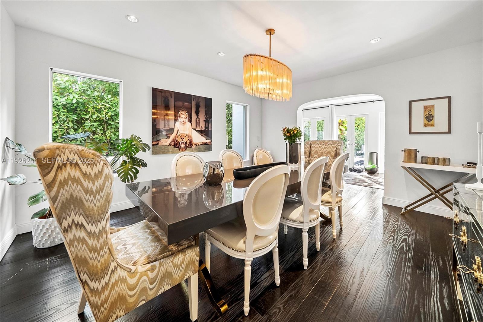 2729 North Bay Road Miami Beach, FL 33140 - Photo 6 of 41 a view of a dining room with furniture a chandelier and wooden floor