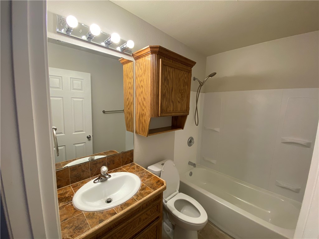 913 Strom Road Corpus Christi, TX 78418 - Photo 11 of 24 a bathroom with a sink toilet a mirror and shower