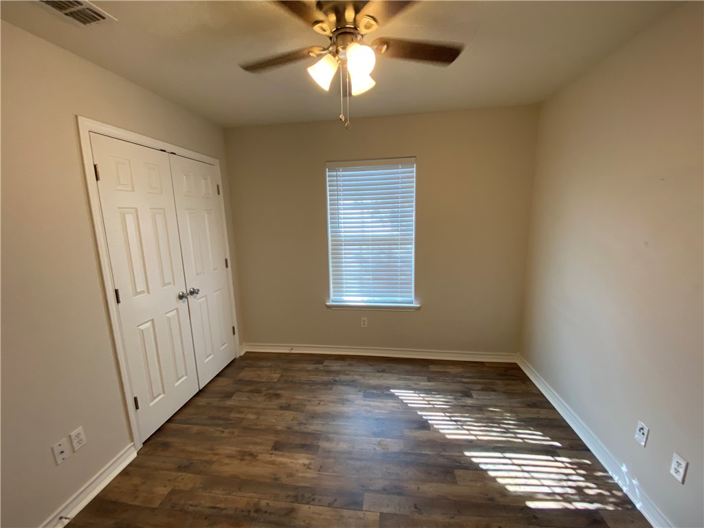 913 Strom Road Corpus Christi, TX 78418 - Photo 13 of 24 wooden floor in an empty room with a window