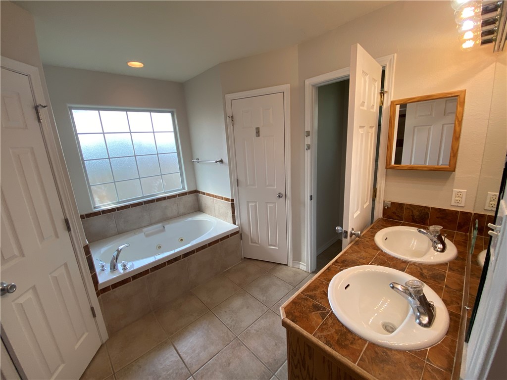 913 Strom Road Corpus Christi, TX 78418 - Photo 17 of 24 a bathroom with a sink a toilet and shower
