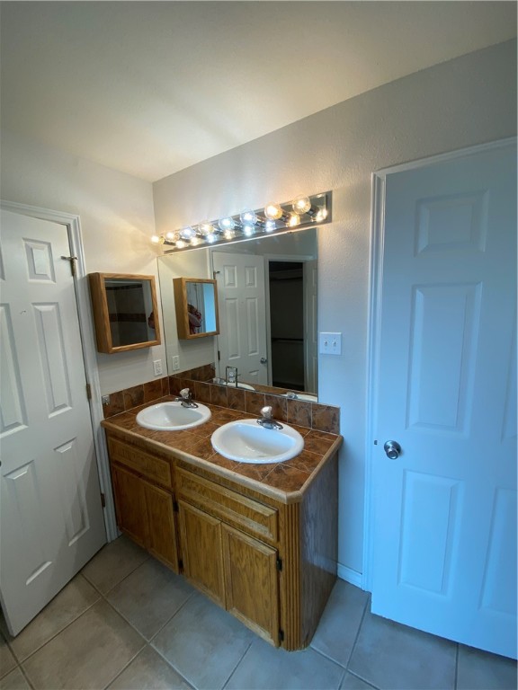 913 Strom Road Corpus Christi, TX 78418 - Photo 22 of 24 a spacious bathroom with a granite countertop sink and a mirror