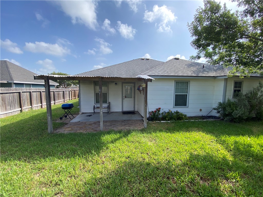 913 Strom Road Corpus Christi, TX 78418 - Photo 24 of 24 a view of a house with a backyard and a patio