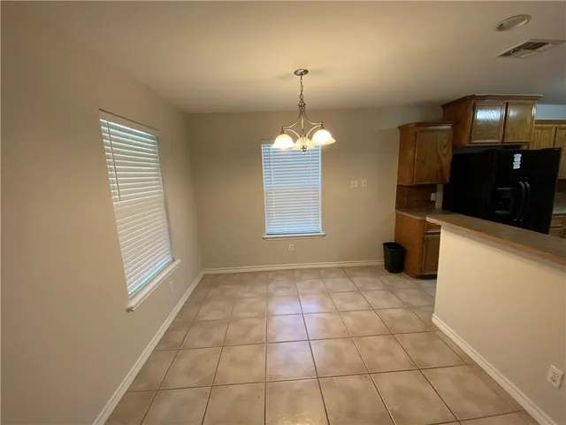 a kitchen with a sink a stove and cabinets