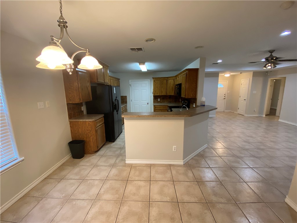 913 Strom Road Corpus Christi, TX 78418 - Photo 5 of 24 a kitchen with a sink a counter space cabinets and appliances