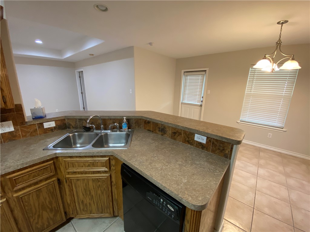 913 Strom Road Corpus Christi, TX 78418 - Photo 6 of 24 a kitchen with a sink a stove and cabinets