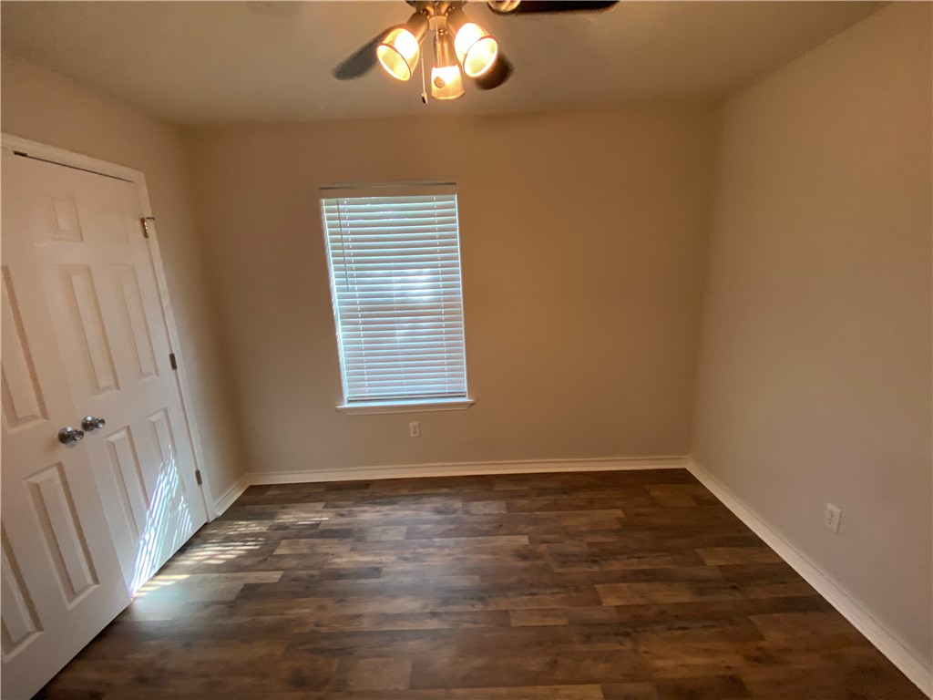 913 Strom Road Corpus Christi, TX 78418 - Photo 7 of 24 an empty room with wooden floor and windows