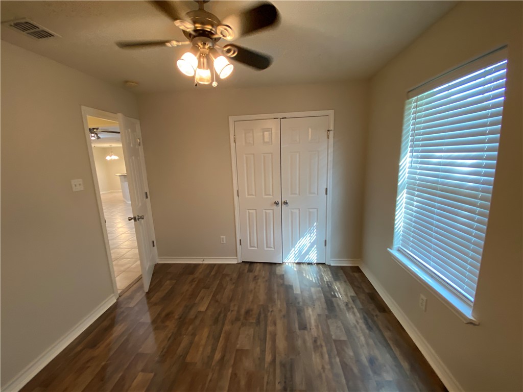 913 Strom Road Corpus Christi, TX 78418 - Photo 8 of 24 wooden floor in an empty room with a window