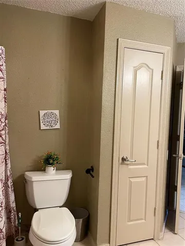 a white toilet sitting next to a bathroom sink