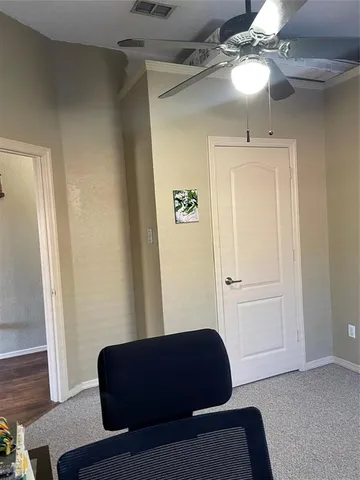 a living room with furniture and a ceiling fan