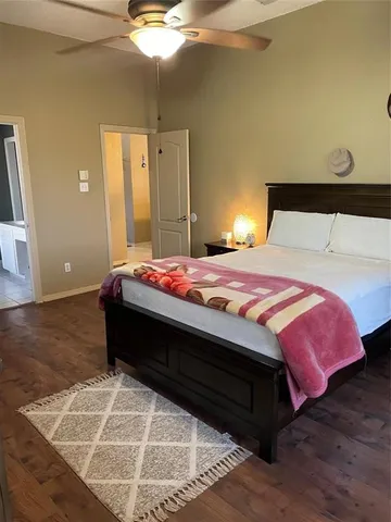 a bedroom with a bed and a night stand