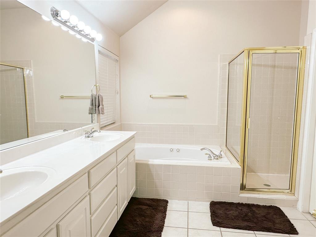 11616 Sweet Basil Court Austin, TX 78726 - Photo 12 of 18 a bathroom with a tub a sink and a mirror