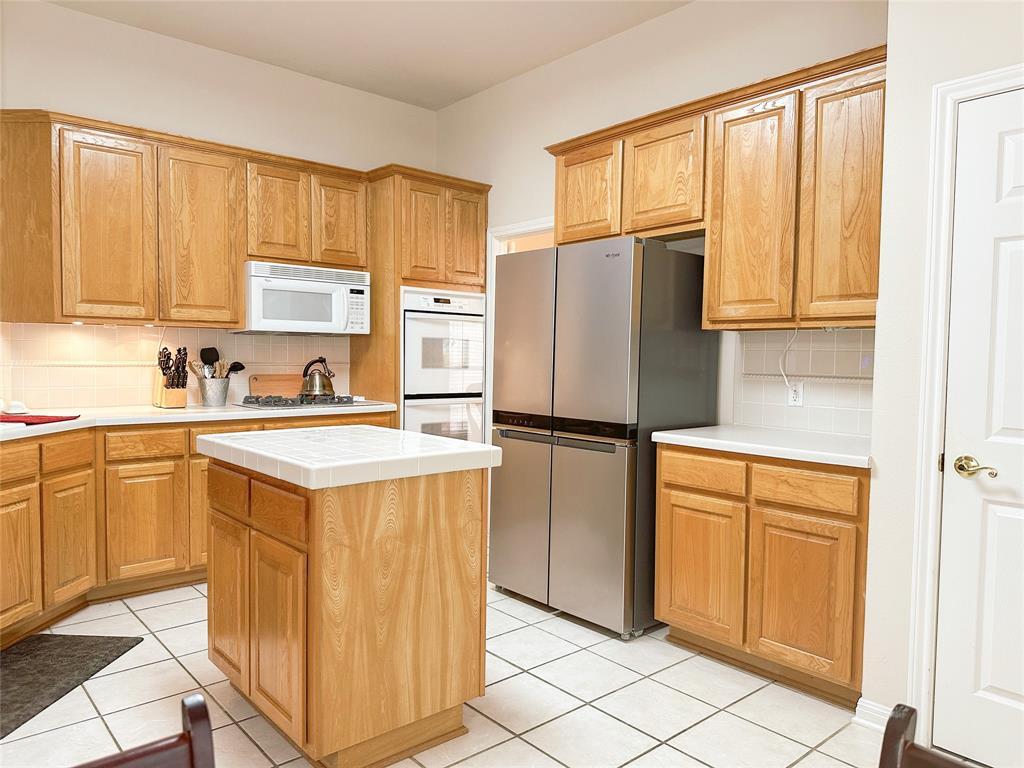 11616 Sweet Basil Court Austin, TX 78726 - Photo 5 of 18 a kitchen with stainless steel appliances granite countertop a refrigerator sink and cabinets
