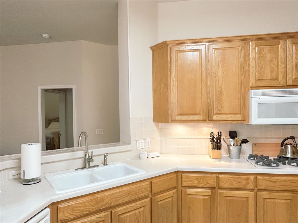 11616 Sweet Basil Court Austin, TX 78726 - Photo 6 of 18 a kitchen with a sink and cabinets