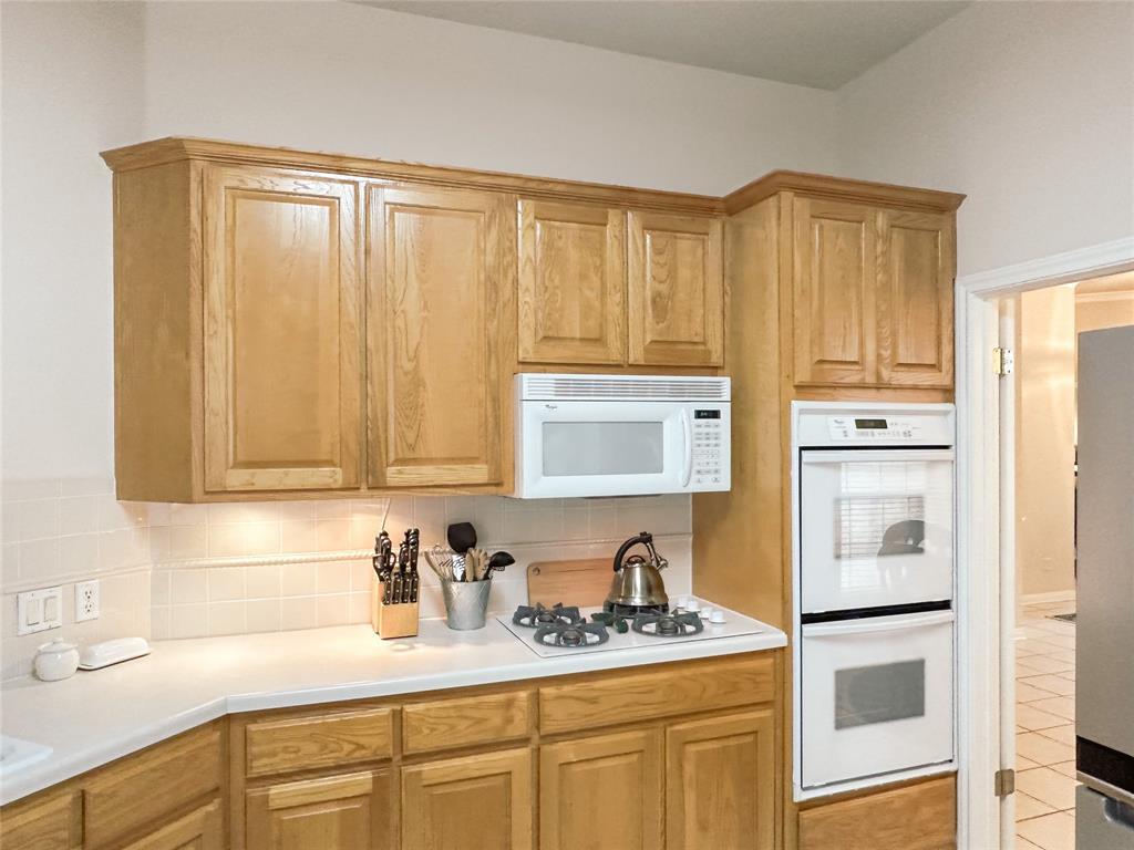 11616 Sweet Basil Court Austin, TX 78726 - Photo 7 of 18 a kitchen with stainless steel appliances granite countertop a sink a stove and cabinets