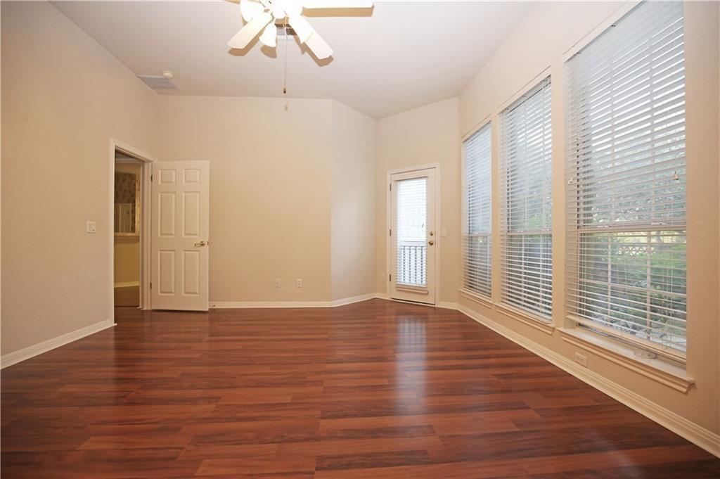 11616 Sweet Basil Court Austin, TX 78726 - Photo 10 of 18 a view of an empty room with wooden floor and a window