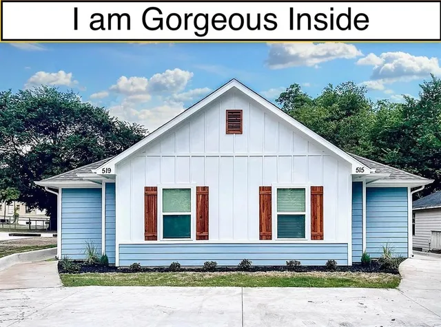 a view of a house with wooden fence