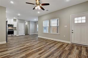 519 West Bond Street Denison, TX 75020 - Photo 3 of 14 a view of an empty room with window and wooden floor