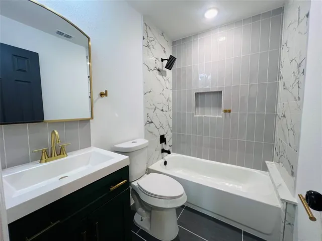 a bathroom with a sink a toilet and a bathtub