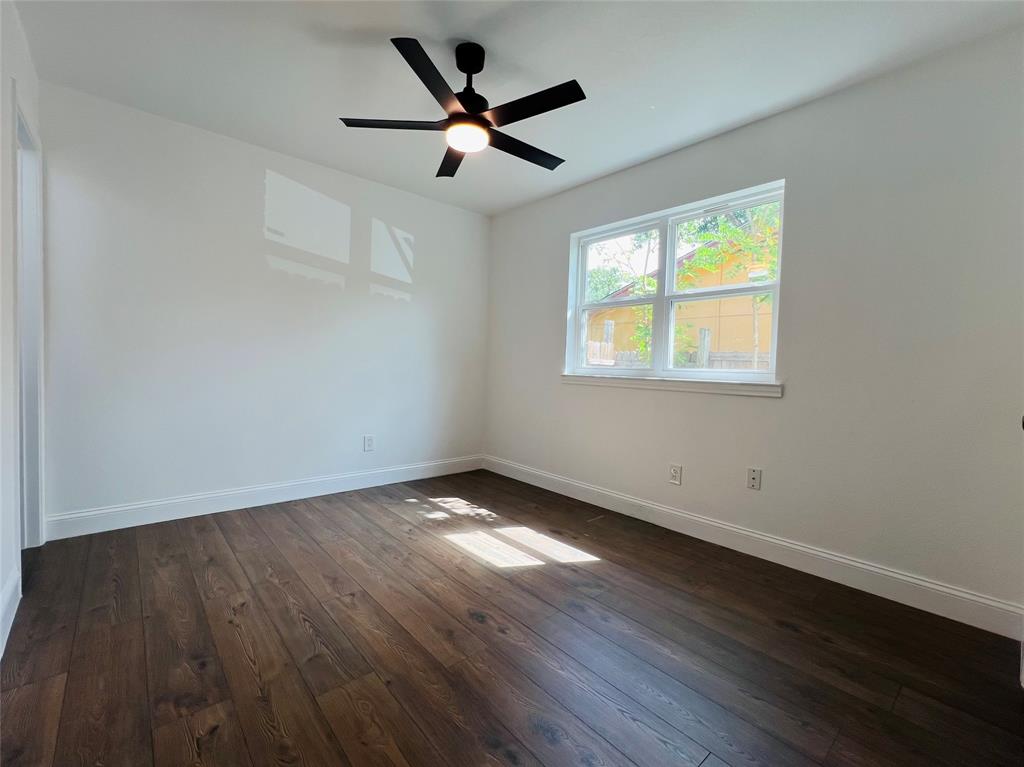1621 Running River Road Garland, TX 75044 - Photo 15 of 20 an empty room with wooden floor and windows
