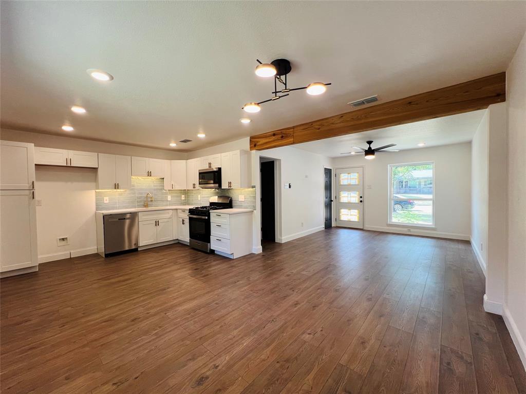 1621 Running River Road Garland, TX 75044 - Photo 6 of 20 a view of a kitchen with a sink and a refrigerator